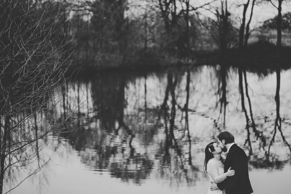 bride and groom kiss near the lake, styal lodge wedding photography, styal lodge wedding photographer, manchester wedding photographer, manchester wedding photography, cheshire wedding photographer, cheshire wedding photography