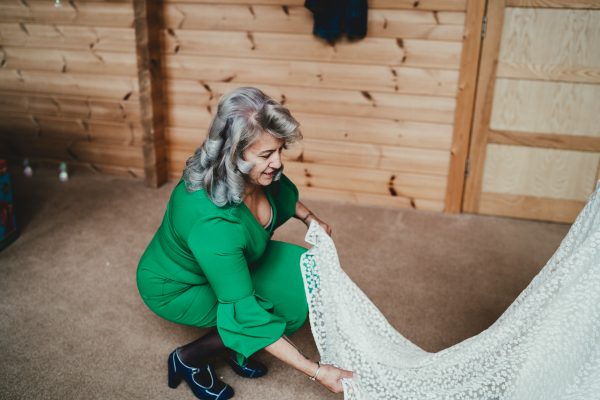 mother of brides organises brides train inside the dressing room, styal lodge wedding photography, styal lodge wedding photographer, manchester wedding photographer, manchester wedding photography, cheshire wedding photographer, cheshire wedding photography