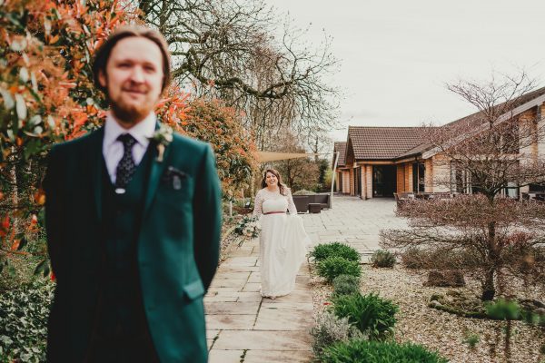 bride walks up to her groom in a garden, styal lodge wedding photography, styal lodge wedding photographer, manchester wedding photographer, manchester wedding photography, cheshire wedding photographer, cheshire wedding photography