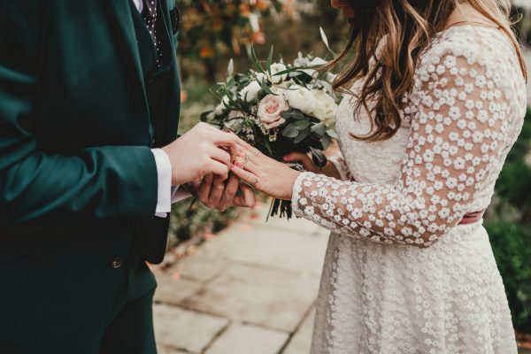 groom puts a ring on his brides finger as she holds her bouquet of flowers, styal lodge wedding photography, styal lodge wedding photographer, manchester wedding photographer, manchester wedding photography, cheshire wedding photographer, cheshire wedding photography