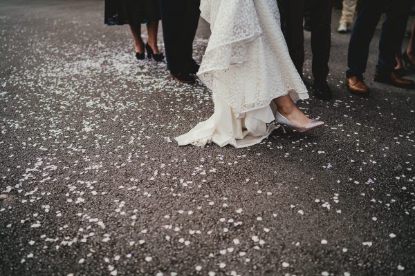 bottom of the brides wedding dress as she steps on to confetti, styal lodge wedding photography, styal lodge wedding photographer, manchester wedding photographer, manchester wedding photography, cheshire wedding photographer, cheshire wedding photography