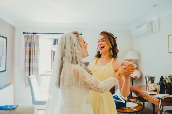 bridesmaid and bride laughing, elsecar heritage centre wedding photographer, elsecar heritage centre wedding photography, elsecar heritage centre wedding, ayesha photographer, manchester wedding photographer, manchester wedding photography, sheffield wedding photographer, sheffield wedding photography, barnsley wedding photographer, innercity weddings