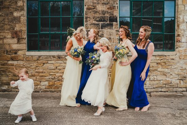 bridemaids laughing as little flower girl runs in front of them, elsecar heritage centre wedding photographer, elsecar heritage centre wedding photography, elsecar heritage centre wedding, ayesha photographer, manchester wedding photographer, manchester wedding photography, sheffield wedding photographer, sheffield wedding photography, barnsley wedding photographer, innercity weddings