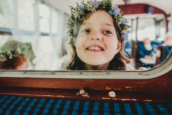 little girl wears a flower crown and squashes her face against the glass window, elsecar heritage centre wedding photographer, elsecar heritage centre wedding photography, elsecar heritage centre wedding, ayesha photographer, manchester wedding photographer, manchester wedding photography, sheffield wedding photographer, sheffield wedding photography, barnsley wedding photographer, innercity weddings